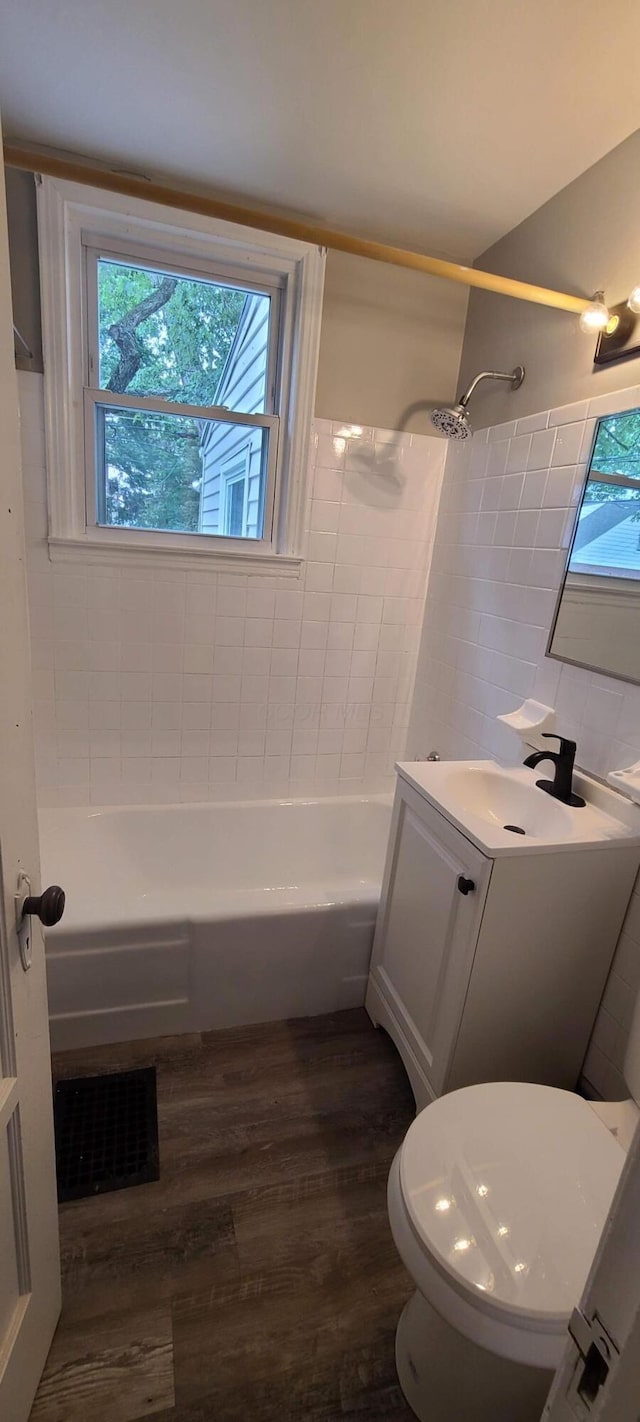 1710 Hess Blvd, Columbus, OH 43212 - bathroom featuring wood finished floors, bathing tub / shower combination, tile walls, and vanity