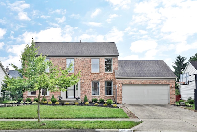 2885 Wynneleaf St, Hilliard, OH 43026 - colonial home featuring brick siding, a garage, concrete driveway, roof with shingles, and a front yard