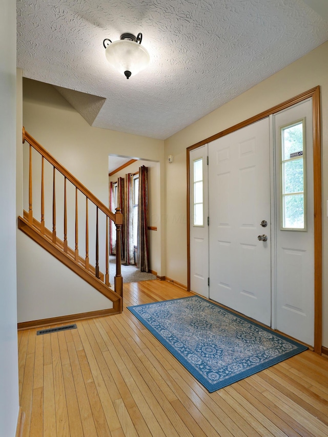 2885 Wynneleaf St, Hilliard, OH 43026 - entryway with plenty of natural light, a textured ceiling, wood-type flooring, and stairway