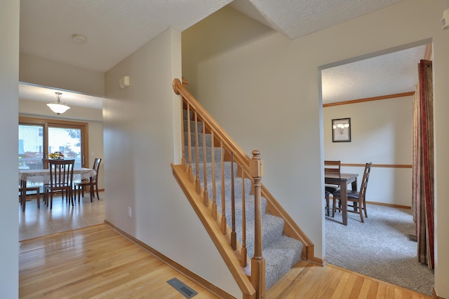 2885 Wynneleaf St, Hilliard, OH 43026 - stairway featuring wood finished floors and a textured ceiling