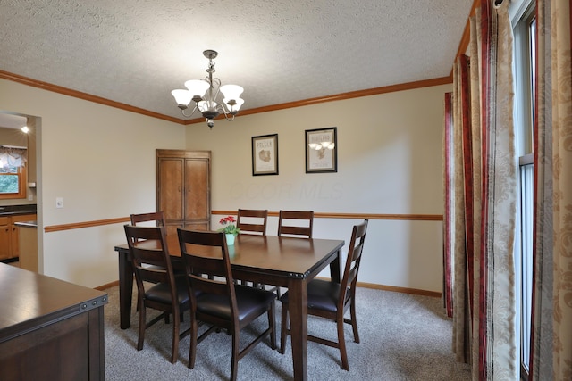 2885 Wynneleaf St, Hilliard, OH 43026 - dining area with a chandelier, light carpet, a textured ceiling, and ornamental molding