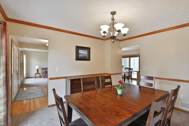 2885 Wynneleaf St, Hilliard, OH 43026 - dining room featuring light colored carpet, a chandelier, and ornamental molding