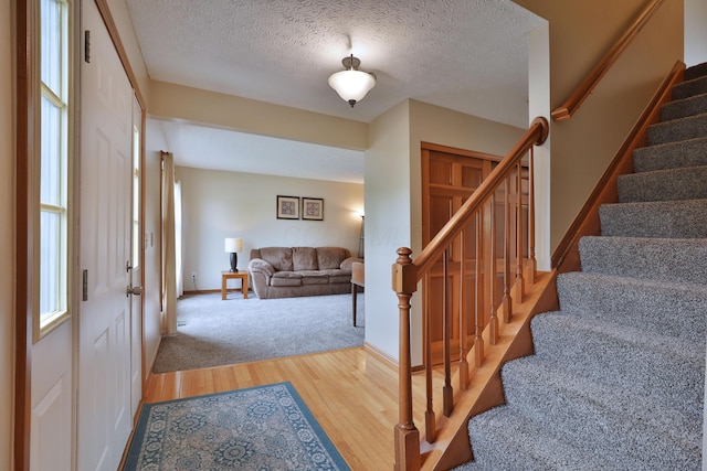 2885 Wynneleaf St, Hilliard, OH 43026 - foyer with wood finished floors, stairway, and a textured ceiling