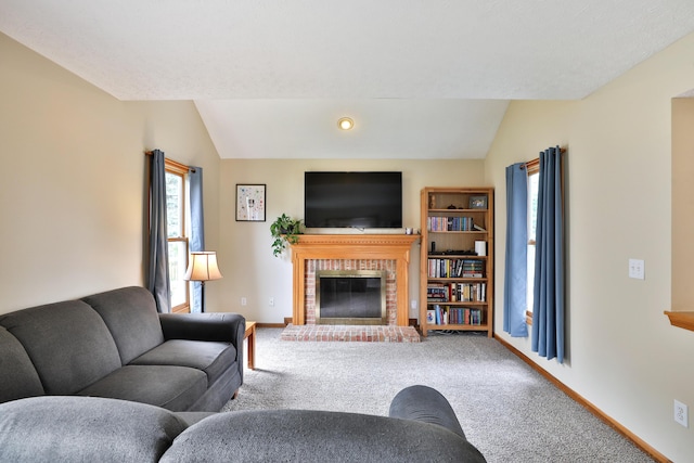 2885 Wynneleaf St, Hilliard, OH 43026 - living room featuring a fireplace, vaulted ceiling, and carpet