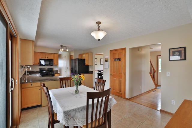 2885 Wynneleaf St, Hilliard, OH 43026 - dining room featuring light tile patterned flooring, a textured ceiling, and stairway