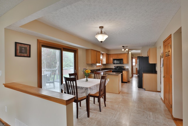 2885 Wynneleaf St, Hilliard, OH 43026 - dining room featuring healthy amount of natural light, a textured ceiling, and light tile patterned floors