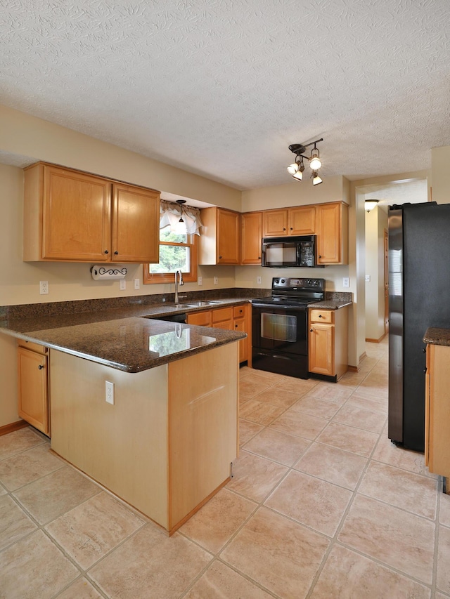 2885 Wynneleaf St, Hilliard, OH 43026 - kitchen featuring black appliances, a peninsula, a textured ceiling, light tile patterned flooring, and dark stone counters