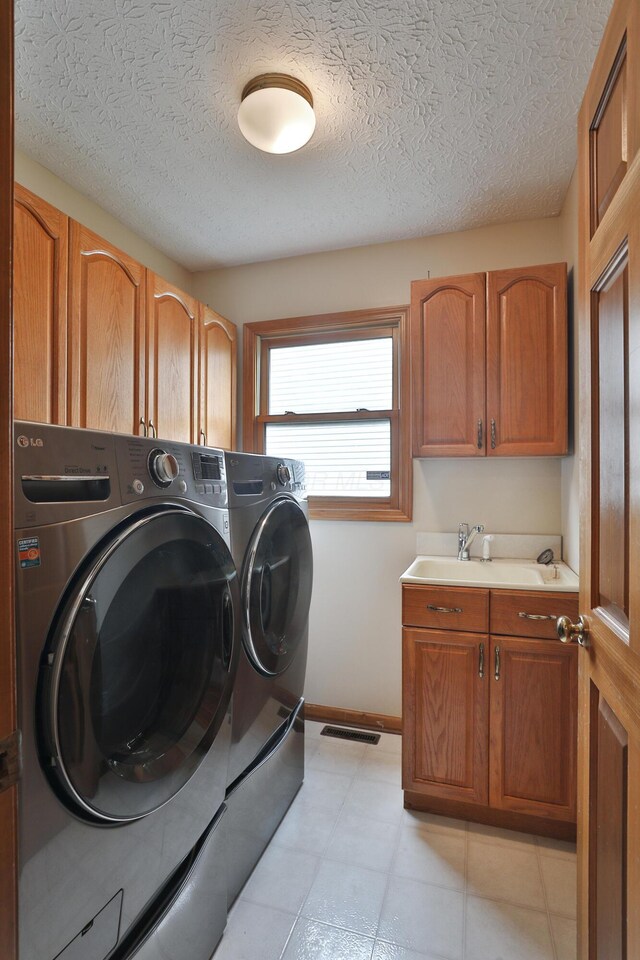 2885 Wynneleaf St, Hilliard, OH 43026 - washroom featuring washing machine and clothes dryer, cabinet space, and a textured ceiling