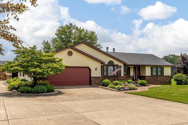 6651 Lancaster Rd, Hebron, OH 43025 - ranch-style house featuring concrete driveway, an attached garage, brick siding, and a front yard