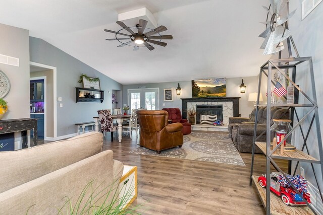 6651 Lancaster Rd, Hebron, OH 43025 - living area with wood finished floors, ceiling fan, vaulted ceiling, and a stone fireplace