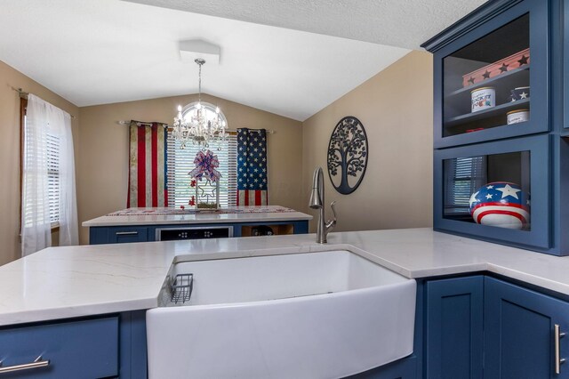 6651 Lancaster Rd, Hebron, OH 43025 - kitchen with blue cabinets, a chandelier, vaulted ceiling, and hanging light fixtures