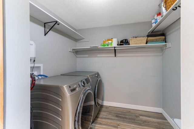 6651 Lancaster Rd, Hebron, OH 43025 - laundry room featuring washer and dryer and wood finished floors
