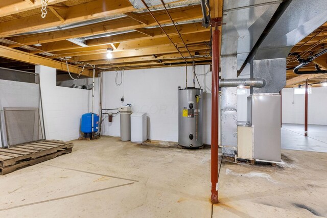 6651 Lancaster Rd, Hebron, OH 43025 - unfinished basement featuring water heater, a water softener, a water pressure tank, and heating unit