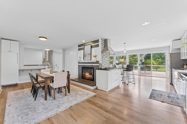 1838 Merriweather Dr, Columbus, OH 43221 - dining space with light wood-style flooring, a fireplace, and recessed lighting