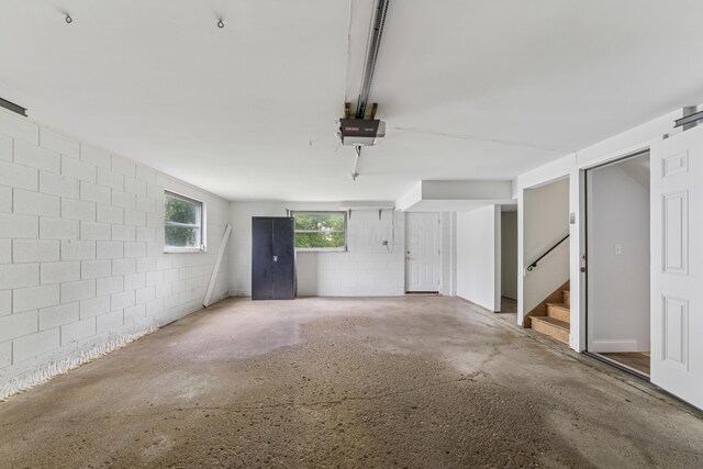 1838 Merriweather Dr, Columbus, OH 43221 - garage featuring a garage door opener and concrete block wall