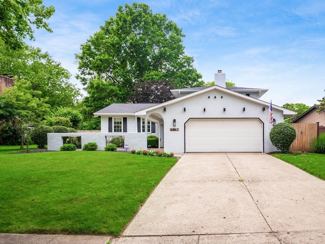 5247 Heathmoor St, Columbus, OH 43235 - view of front facade featuring an attached garage, concrete driveway, and a chimney