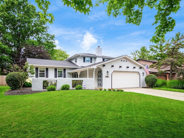5247 Heathmoor St, Columbus, OH 43235 - split level home with an attached garage, driveway, a chimney, and stucco siding