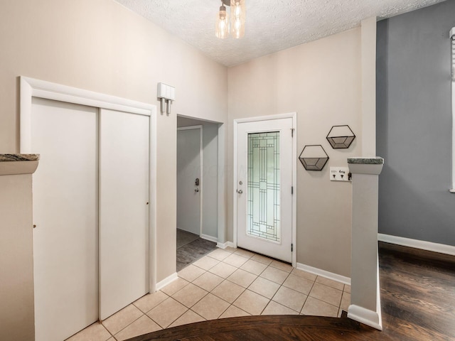 5247 Heathmoor St, Columbus, OH 43235 - foyer entrance featuring a textured ceiling and light wood finished floors