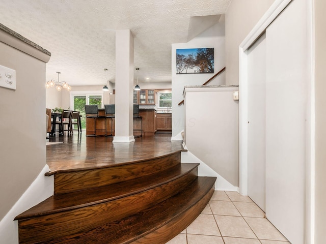 5247 Heathmoor St, Columbus, OH 43235 - stairway featuring a textured ceiling and tile patterned floors