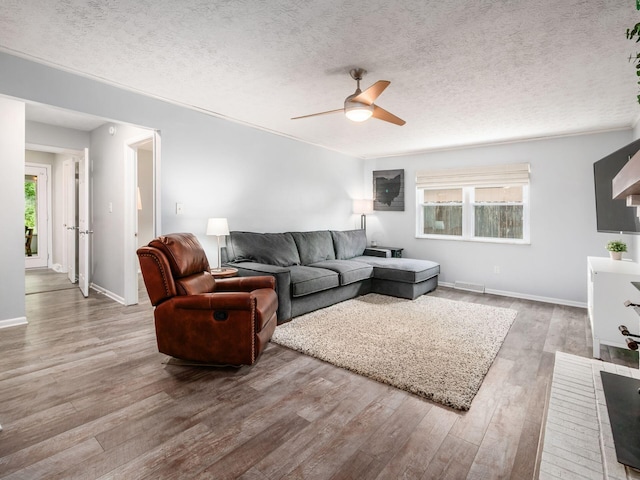 5247 Heathmoor St, Columbus, OH 43235 - living room featuring a ceiling fan, wood finished floors, and a textured ceiling