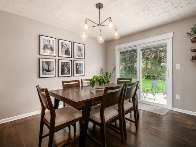 5247 Heathmoor St, Columbus, OH 43235 - dining area featuring dark wood finished floors, a textured ceiling, and a chandelier