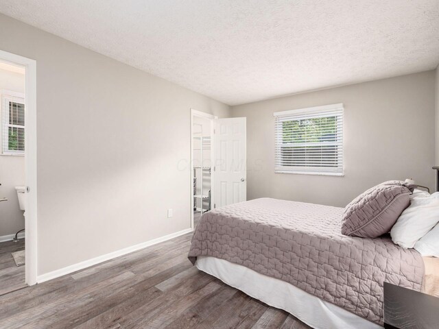 5247 Heathmoor St, Columbus, OH 43235 - bedroom with wood finished floors and a textured ceiling