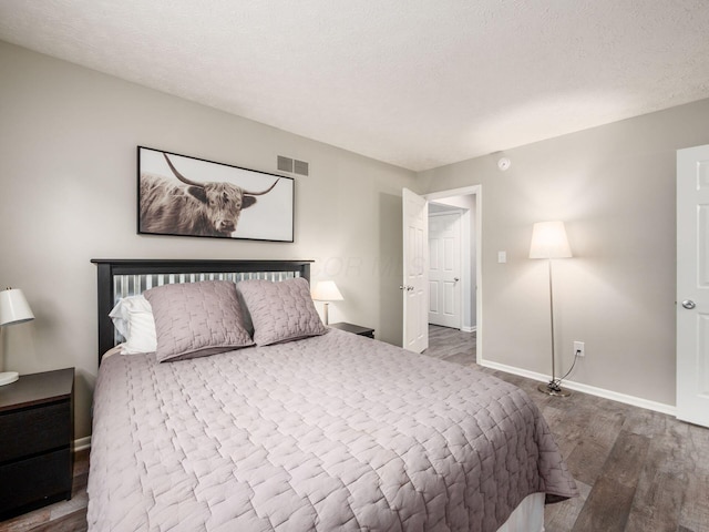 5247 Heathmoor St, Columbus, OH 43235 - bedroom featuring wood finished floors and a textured ceiling