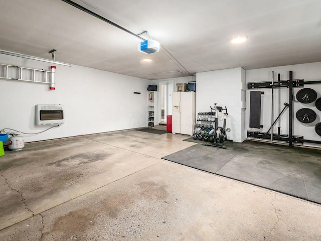 5247 Heathmoor St, Columbus, OH 43235 - garage featuring white fridge with ice dispenser, a garage door opener, and heating unit
