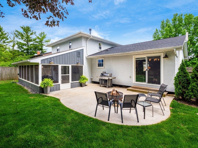 5247 Heathmoor St, Columbus, OH 43235 - back of property with a sunroom, an outdoor fire pit, a patio area, stucco siding, and a shingled roof