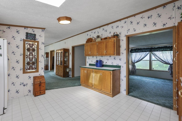 11791 Coontz Rd, Orient, OH 43146 - kitchen featuring ornamental molding, light carpet, wallpapered walls, freestanding refrigerator, and a textured ceiling