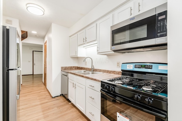 4963 Buck Thorn Ln, Columbus, OH 43220 - kitchen with appliances with stainless steel finishes, light wood finished floors, white cabinetry, recessed lighting, and light countertops