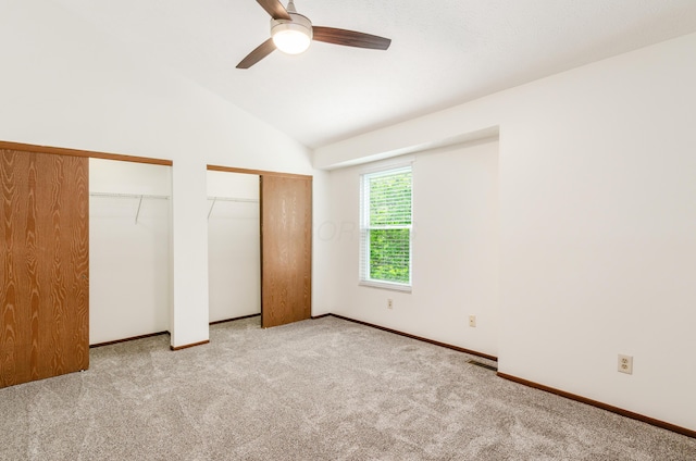 4963 Buck Thorn Ln, Columbus, OH 43220 - unfurnished bedroom featuring two closets, carpet, vaulted ceiling, and a ceiling fan