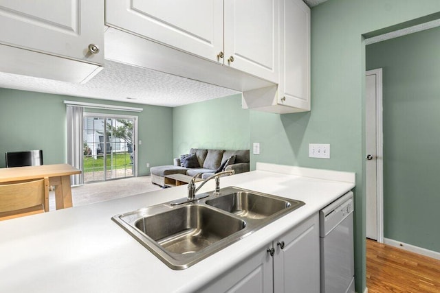 4635 Shalers Dr Unit 44D, Columbus, OH 43228 - kitchen with dishwasher, light countertops, white cabinets, open floor plan, and light wood-style flooring