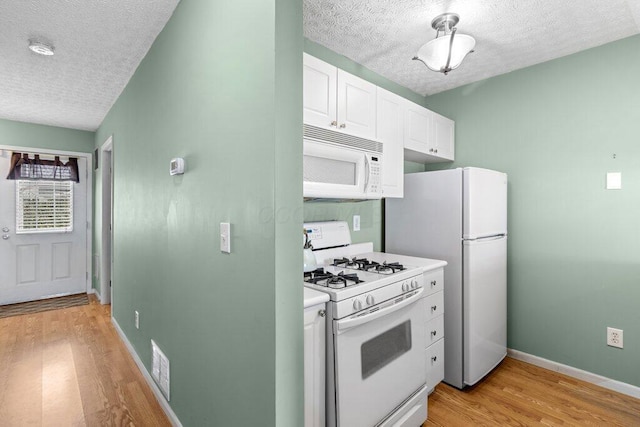 4635 Shalers Dr Unit 44D, Columbus, OH 43228 - kitchen with white appliances, a textured ceiling, light wood-style floors, white cabinetry, and light countertops