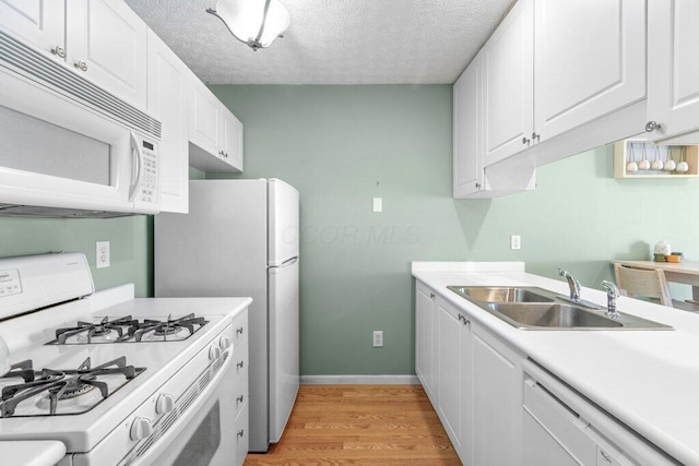 4635 Shalers Dr Unit 44D, Columbus, OH 43228 - kitchen with white appliances, light wood-style flooring, white cabinetry, light countertops, and a textured ceiling