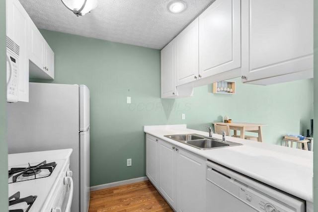 4635 Shalers Dr Unit 44D, Columbus, OH 43228 - kitchen with white appliances, light wood-style flooring, white cabinetry, and a textured ceiling
