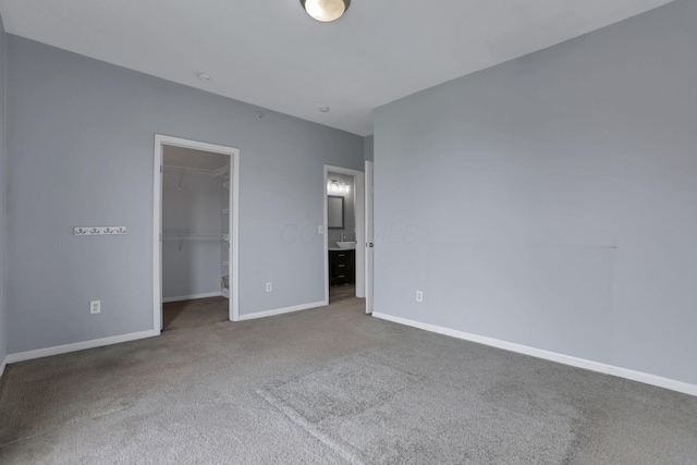 336 S 3rd St Unit 3, Columbus, OH 43215 - unfurnished bedroom featuring carpet, a walk in closet, a closet, and ensuite bath