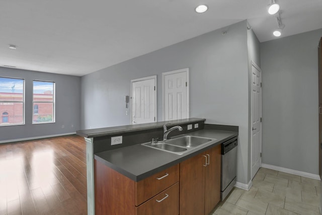 336 S 3rd St Unit 3, Columbus, OH 43215 - kitchen featuring dishwasher, dark countertops, a peninsula, open floor plan, and brown cabinets