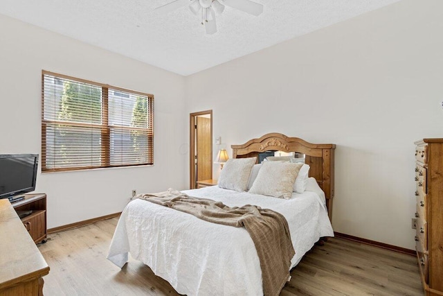 8000 Leaview Dr, Columbus, OH 43235 - bedroom with light wood finished floors, a ceiling fan, and a textured ceiling