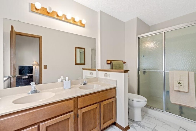 8000 Leaview Dr, Columbus, OH 43235 - full bath with double vanity, a shower stall, marble look tiles, and a textured ceiling