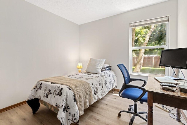 8000 Leaview Dr, Columbus, OH 43235 - bedroom featuring wood finished floors, a desk, and a textured ceiling