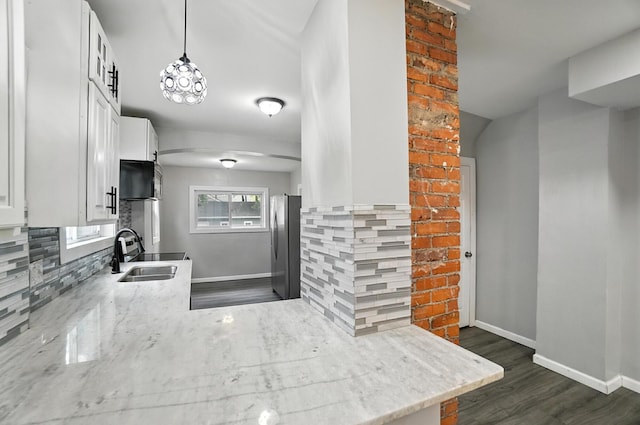 668 Bulen Ave, Columbus, OH 43205 - kitchen featuring dark wood finished floors, white cabinets, light stone countertops, and appliances with stainless steel finishes