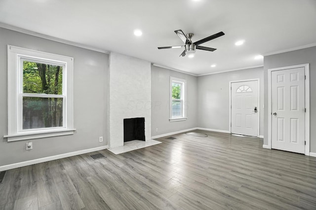 668 Bulen Ave, Columbus, OH 43205 - unfurnished living room featuring ceiling fan, ornamental molding, wood finished floors, a fireplace, and recessed lighting