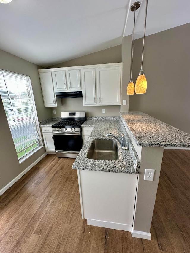 3251 Foxpoint Dr, Hilliard, OH 43026 - kitchen with stainless steel gas range, under cabinet range hood, light stone counters, wood finished floors, and lofted ceiling