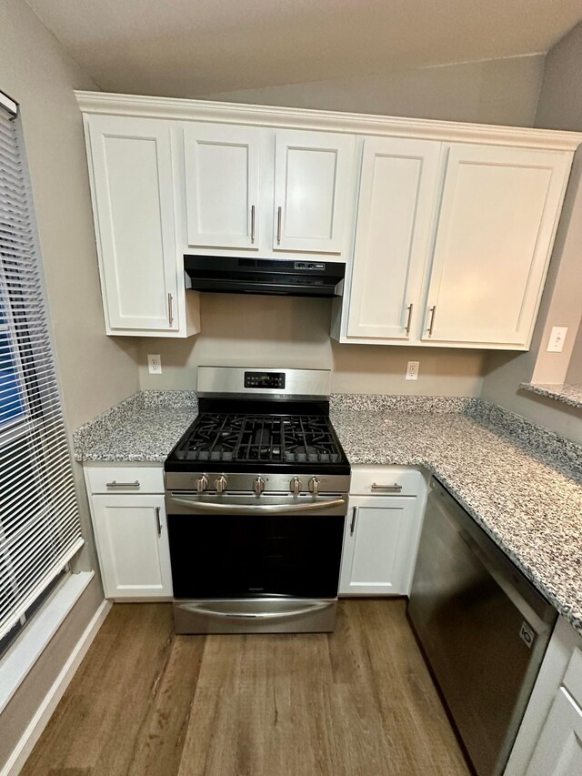 3251 Foxpoint Dr, Hilliard, OH 43026 - kitchen with stainless steel appliances, under cabinet range hood, wood finished floors, white cabinets, and light stone counters