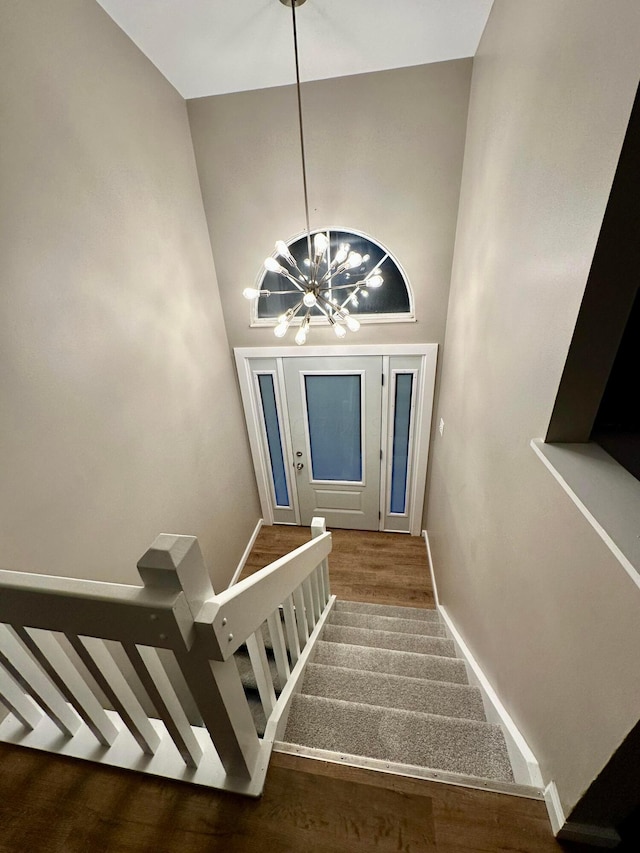 3251 Foxpoint Dr, Hilliard, OH 43026 - stairs with a chandelier, wood finished floors, and a high ceiling