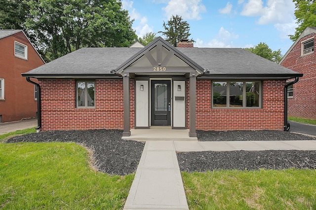 2850 E Moreland Dr, Columbus, OH 43209 - bungalow-style home with brick siding, a chimney, and roof with shingles