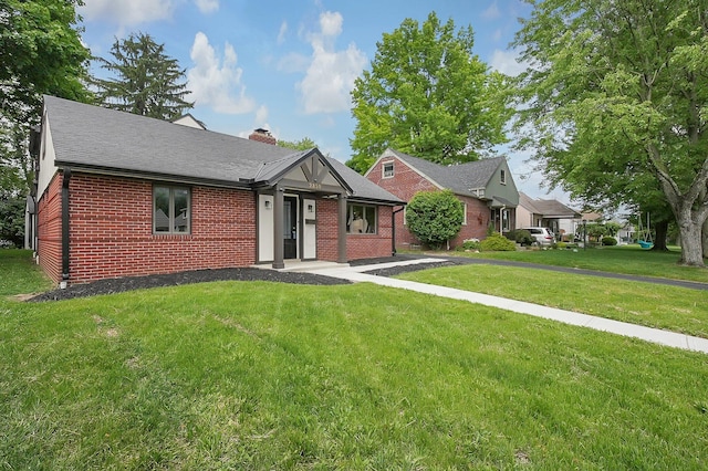 2850 E Moreland Dr, Columbus, OH 43209 - view of front facade featuring brick siding, a chimney, a front lawn, and a shingled roof