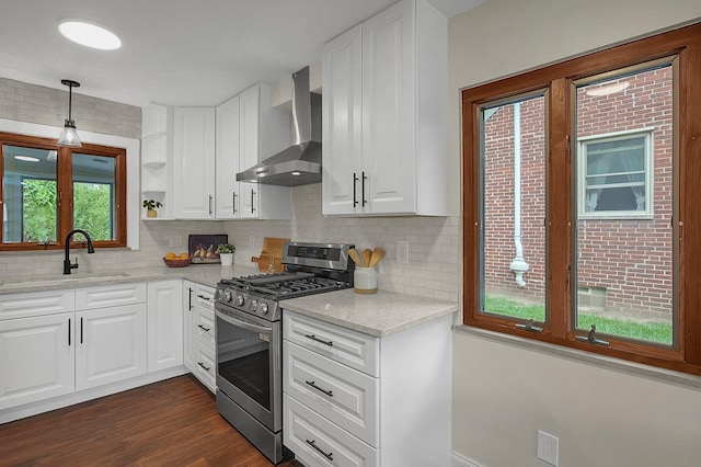 2850 E Moreland Dr, Columbus, OH 43209 - kitchen featuring stainless steel range with gas cooktop, wall chimney exhaust hood, tasteful backsplash, white cabinets, and dark wood finished floors