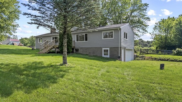 8149 Outville Rd SW, Pataskala, OH 43062 - back of property with stairs, an attached garage, a chimney, and a wooden deck